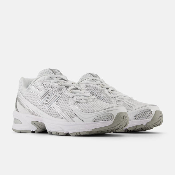 Pair of white running shoes on a light gray background