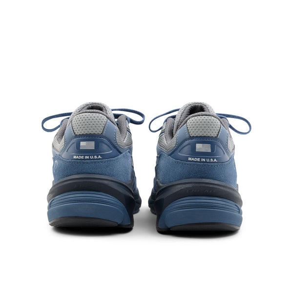 Blue athletic shoes with 'Made in U.S.A.' label on a white background.