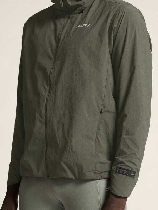 Green jacket with brand logo on a neutral background