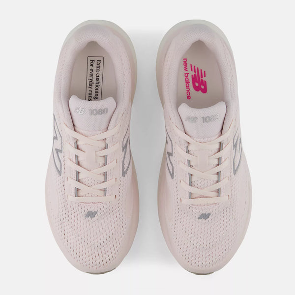 Pair of light pink New Balance sneakers on a white background