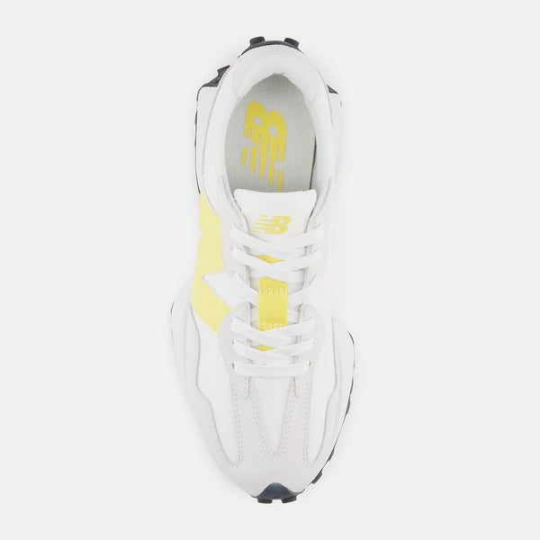 White sneaker with yellow accents on a white background