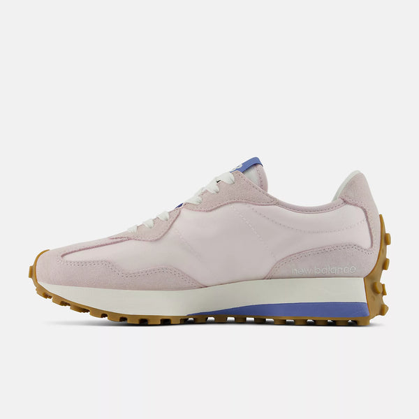 Pink sneaker with a white sole on a light gray background