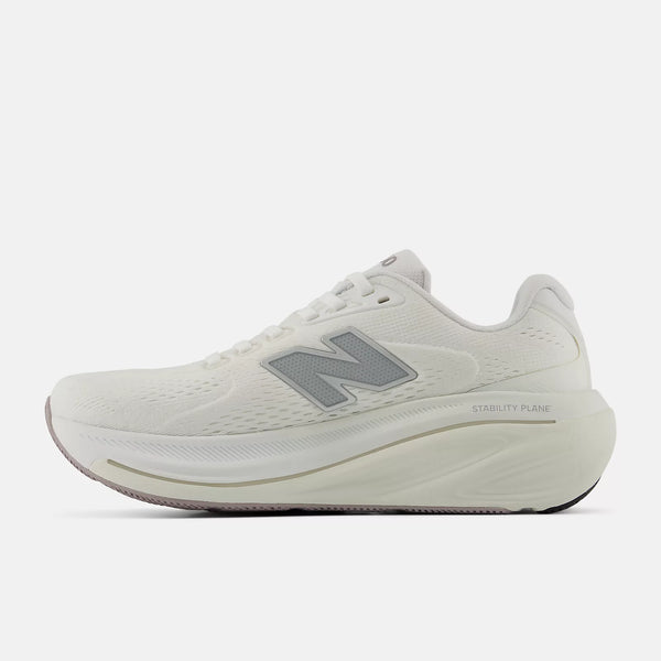 Medial side of a white and silver New Balance running shoe.