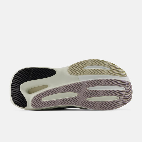 Close-up of a shoe sole with a white and black design on a light gray background