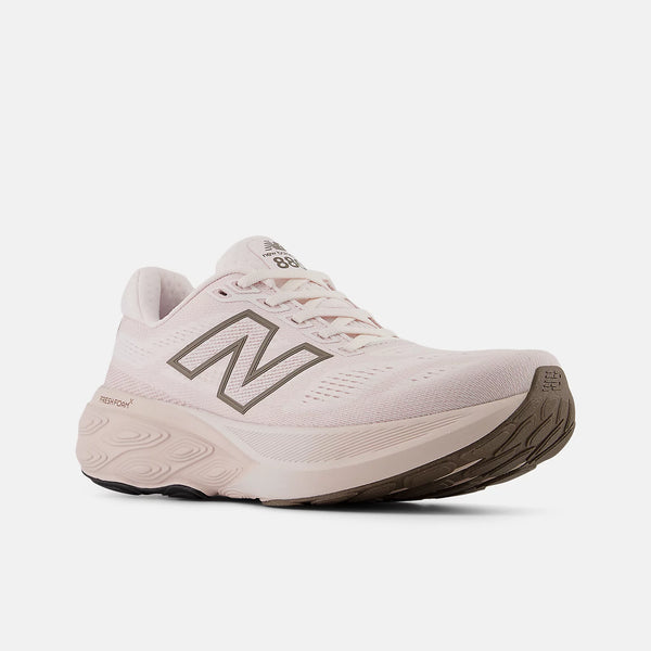 Cery light pink and off white running shoe with 'N' logo on a white background