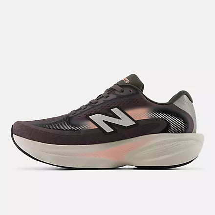 A pair of New Balance running shoes in dark brown and black with a white midsole and subtle pink accents, shown against a light gray background.