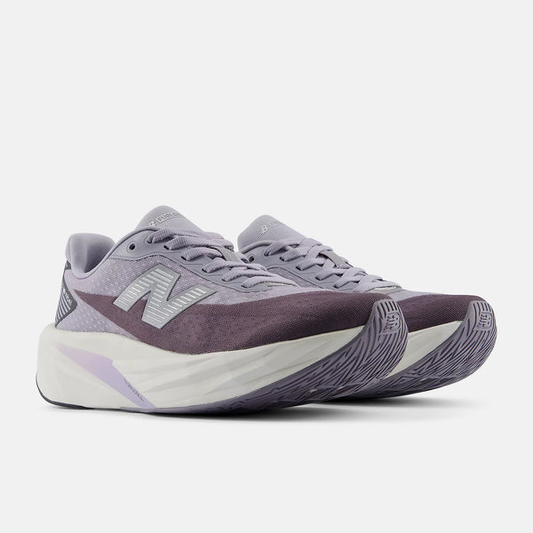 A pair of New Balance running shoes in a muted purple and gray colorway, featuring a thick white and purple midsole, shown against a light gray background.