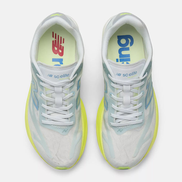 A pair of New Balance SCelite running shoes shown from a top-down view. The shoes feature a white mesh upper with light blue and lime green accents, white laces, and a bright lime green outsole.