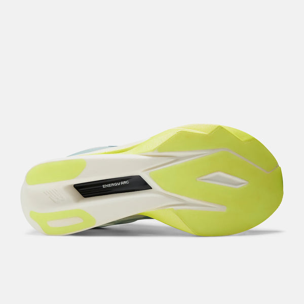 The bottom sole of a New Balance running shoe, showing a bright neon yellow-green and white design with a black EnergyTec cushioning plate.