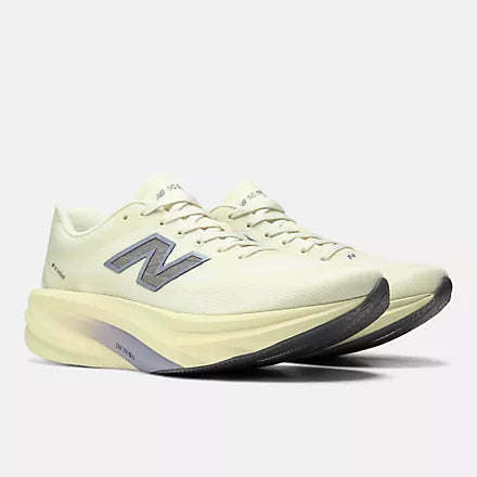 A New Balance running shoe in a pale cream-yellow colorway, featuring a textured mesh upper, matching laces, a thick sculpted foam midsole, and a metallic silver 'N' logo on the side.