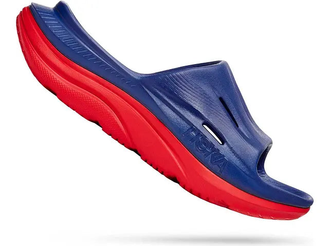 Lateral angled view of the Men's Ora Recovery Slide 3 by HOKA in the color Bellwether Blue/Red