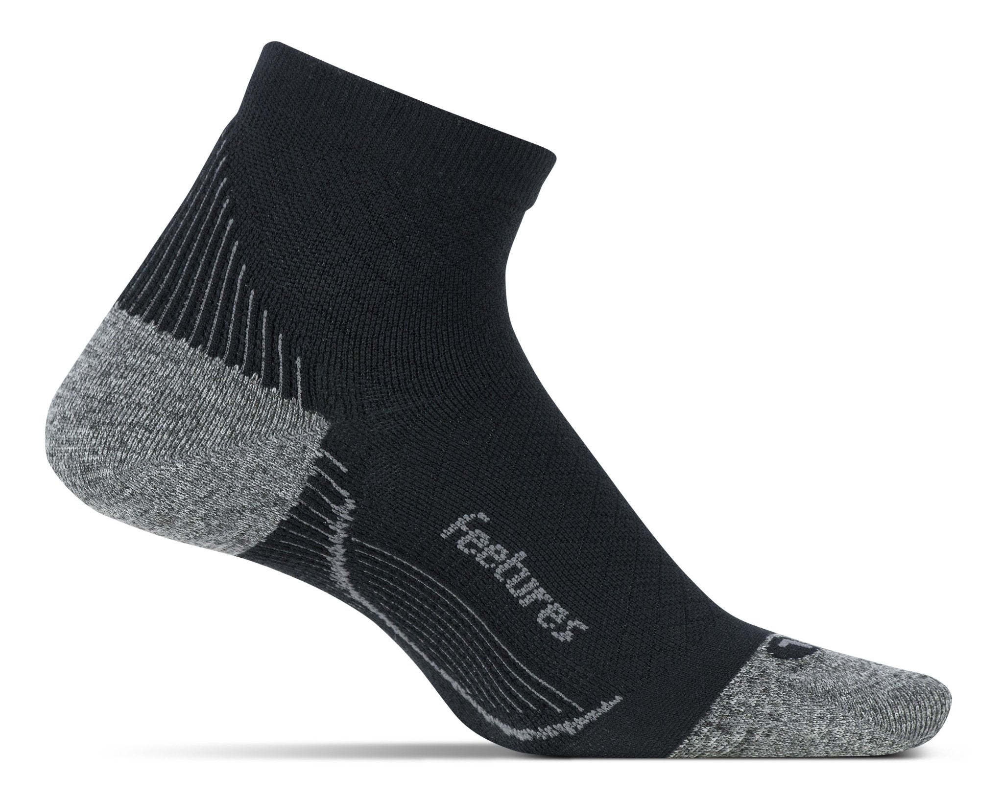 A medial view of the Feetures Plantar Fasciitis Quarter Sock (left foot) in the color black