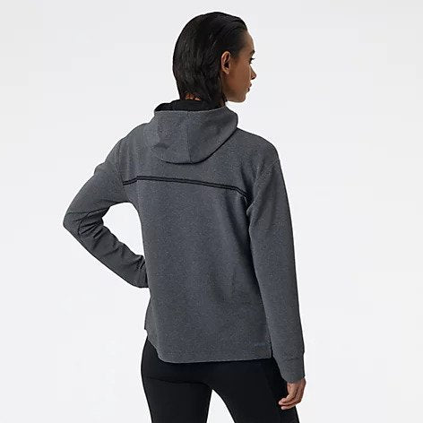 Back view of a model wearing the Women's Q Speed Shift Hoodie by New Balance in the color Black Heather