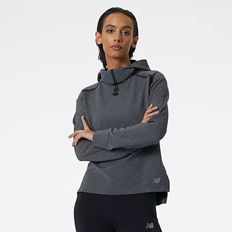 Front view of a model wearing the Women's Q Speed Shift Hoodie by New Balance in the color Black Heather