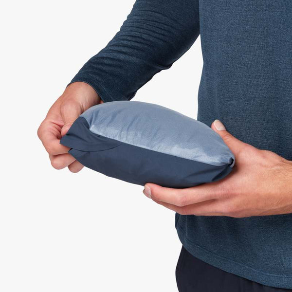 Zoomed in view of a model holding the Men's Waterproof Anorak jacket folded up in it's packable pouch