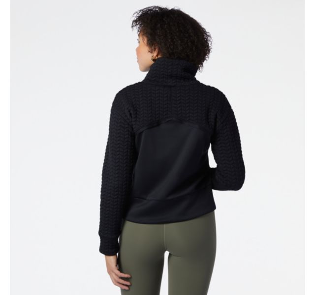 Back view of a model wearing the Women's Heat Loft Pullover by New Balance in Black