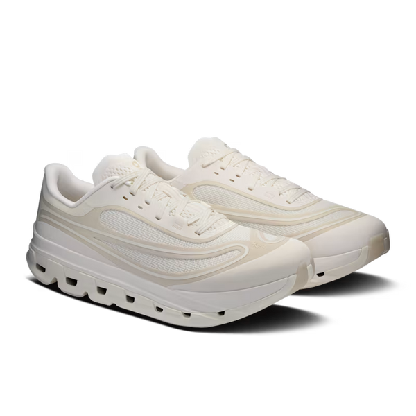A pair of low-top athletic sneakers in a monochromatic cream and off-white colorway, featuring a thick sculpted sole and mesh panels, shown against a plain white background.