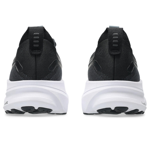 Black running shoes with white soles on a white background.