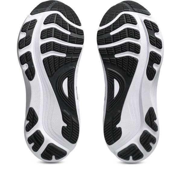 Close-up of black and white athletic shoe soles on a white background.