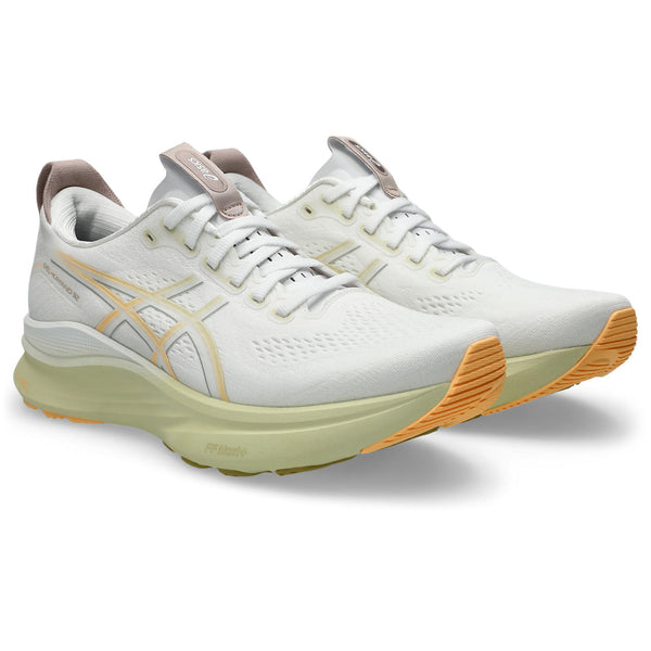 A pair of running shoes with an off white midsole and bright outsole.