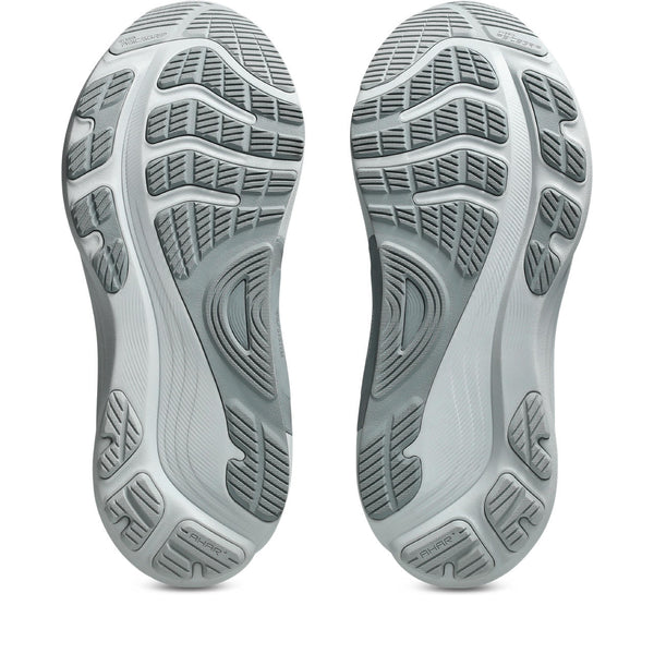 Close-up of the sole of a gray athletic shoe with tread pattern on a white background.
