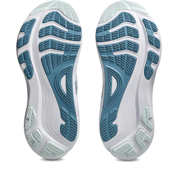 Close-up of the sole of a white athletic shoe with blue tread pattern on a white background