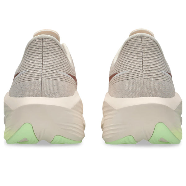 Pair of gray slip-on shoes with green accents on a white background