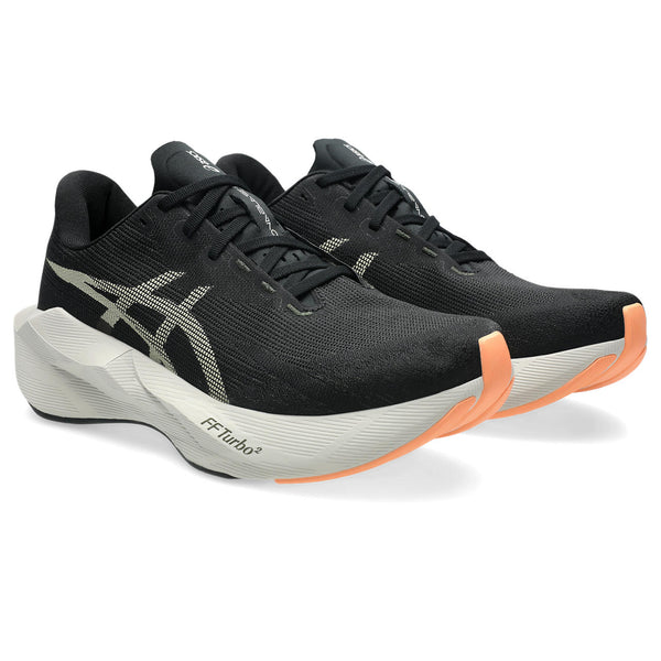 This pair of shoes has black laces and a big ASICS logo in the middle of the foot.