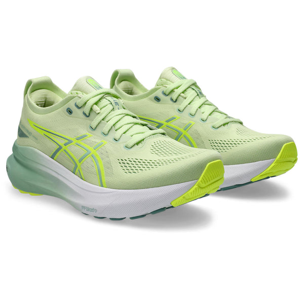A pair of light green Women's ASICS running shoes with white sole on a white background.