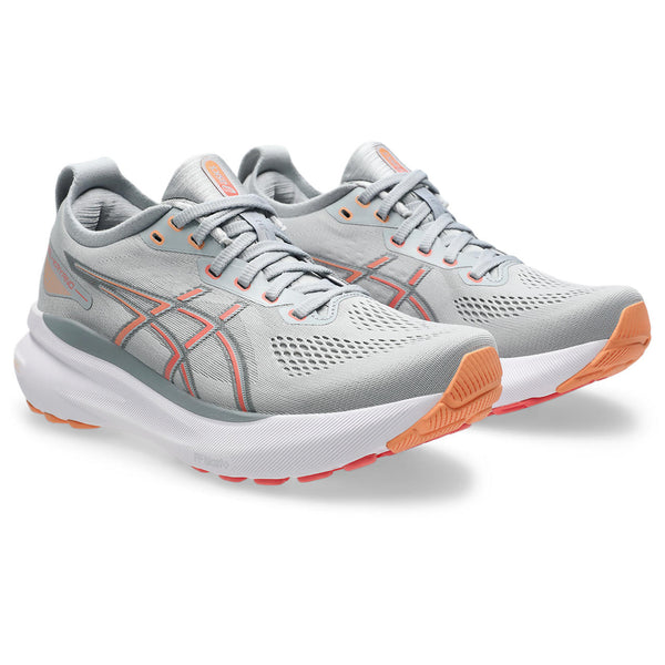 These wide Kayano 31 running shoes have a grey upper and small hits of a coral color.