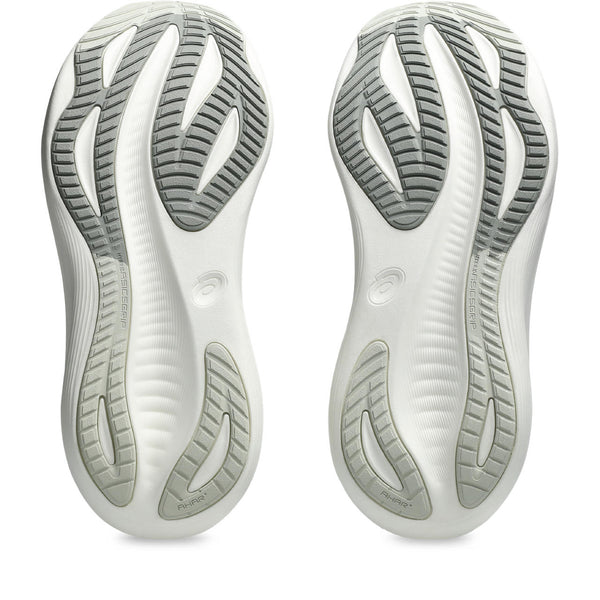 Close-up of a pair of white athletic shoes with tread pattern on a white background.