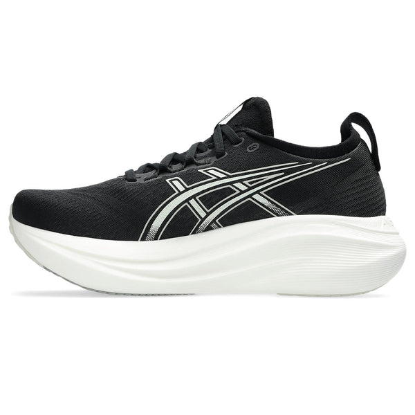Medial side of a mens's black running shoe with white sole on a white background.