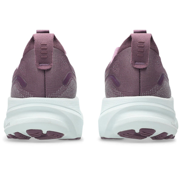 Purple running shoes with white soles on a white background