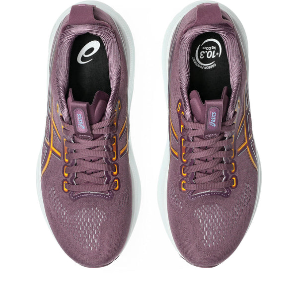 Pair of purple running shoes with yellow accents on a white background
