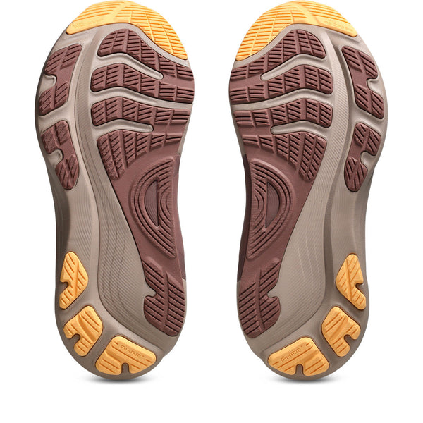 Close-up of the sole of a shoe with brown and yellow tread pattern on a white background