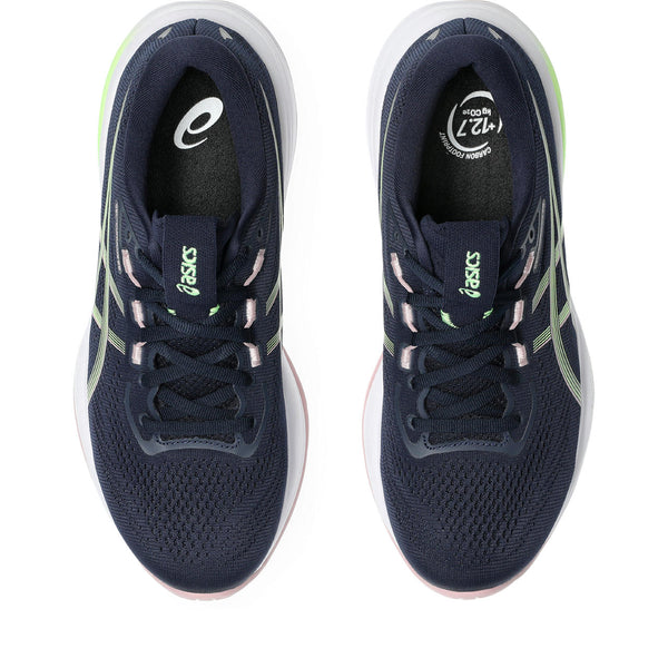 Navy running shoes with green accents on a white background
