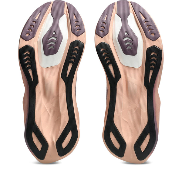 Pair of rose gold insoles with black and white accents on a white background