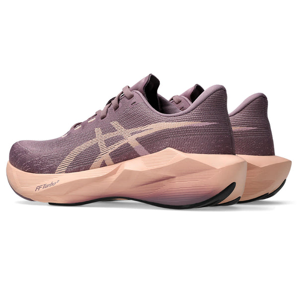 Purple running shoes with a unique sole design on a white background
