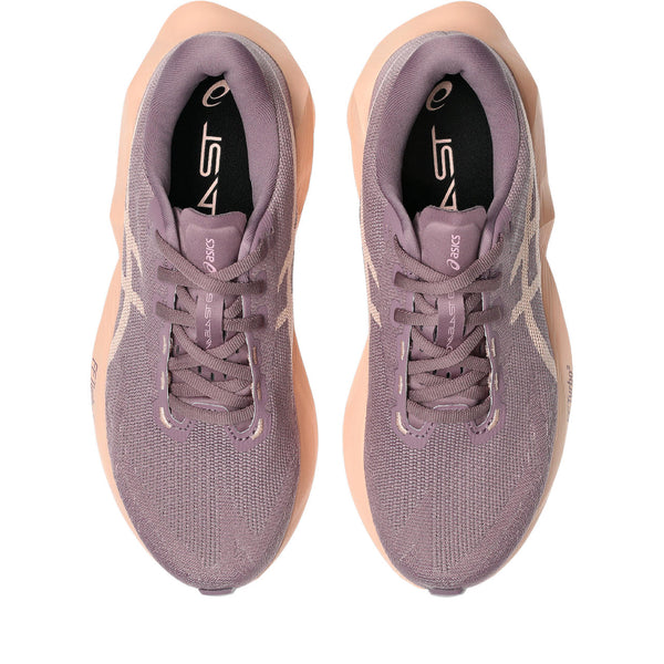 Pair of purple running shoes with beige soles on a white background