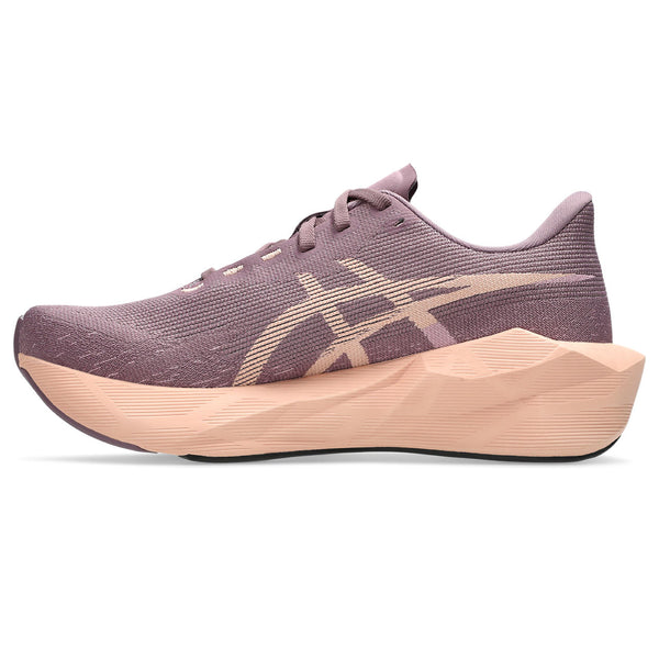 Purple running shoe with a beige sole on a white background