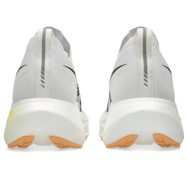Gray athletic shoes with orange soles on a white background