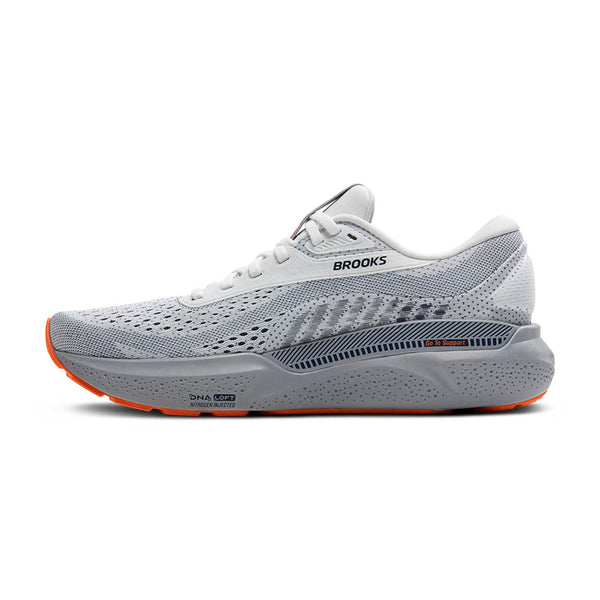 Gray Brooks running shoe with orange sole on a white background.