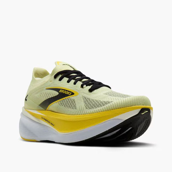 Yellow running shoe with black accents on a white background
