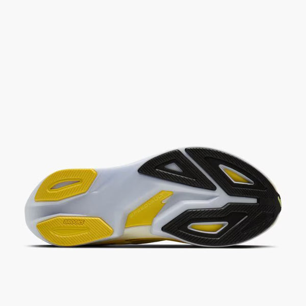 Yellow running shoe with black accents on a white background