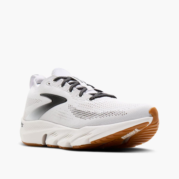 White running shoe with brown sole on a white background