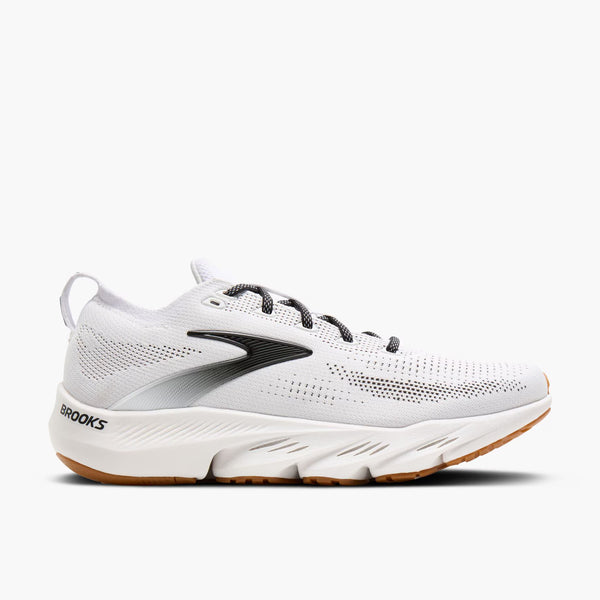 White running shoe with brown sole on a white background
