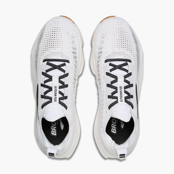 White athletic shoes with black laces and accents on a white background