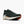 A dark green running shoe with a white midsole and orange outsole accents, shown on a light gray background.