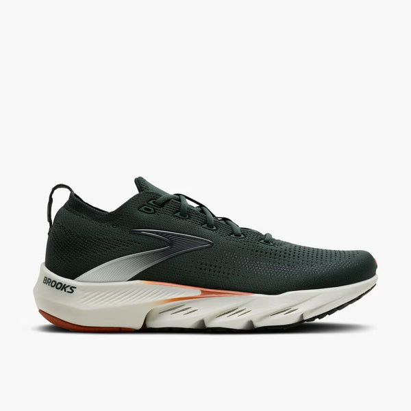A dark green running shoe with a white midsole and orange outsole accents, shown on a light gray background.