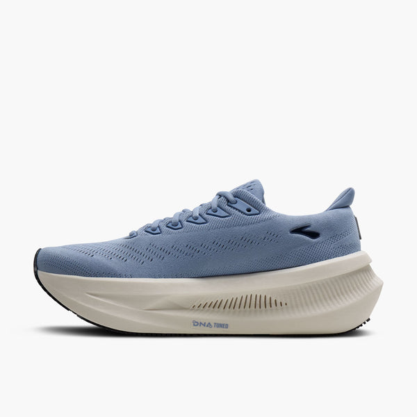 A light blue running shoe with a thick, sculpted off-white DNA-INS midsole and a black outsole, shown from a side profile on a light gray background.